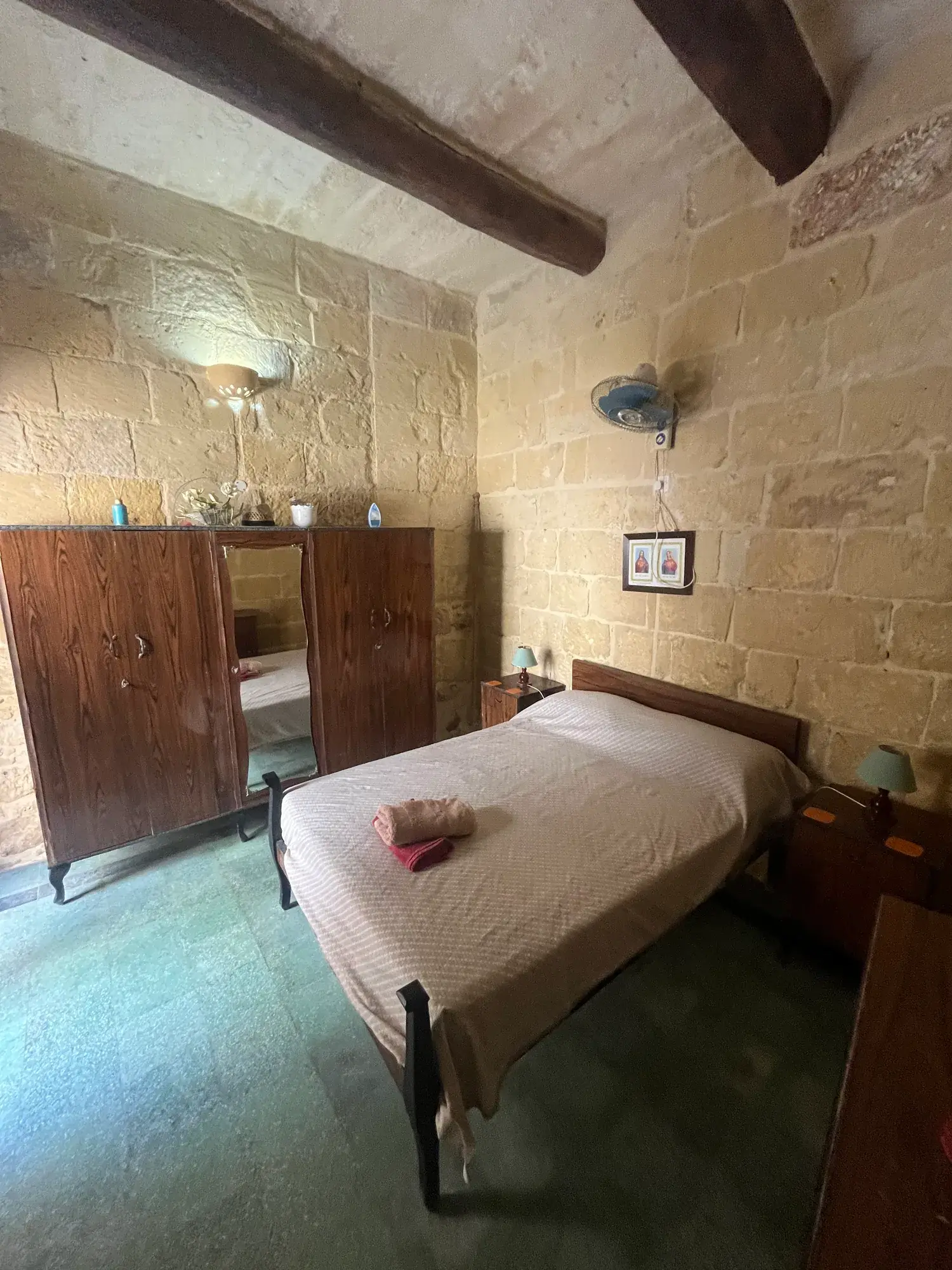 Casa Barone double bedroom with exposed limestone and timber beams