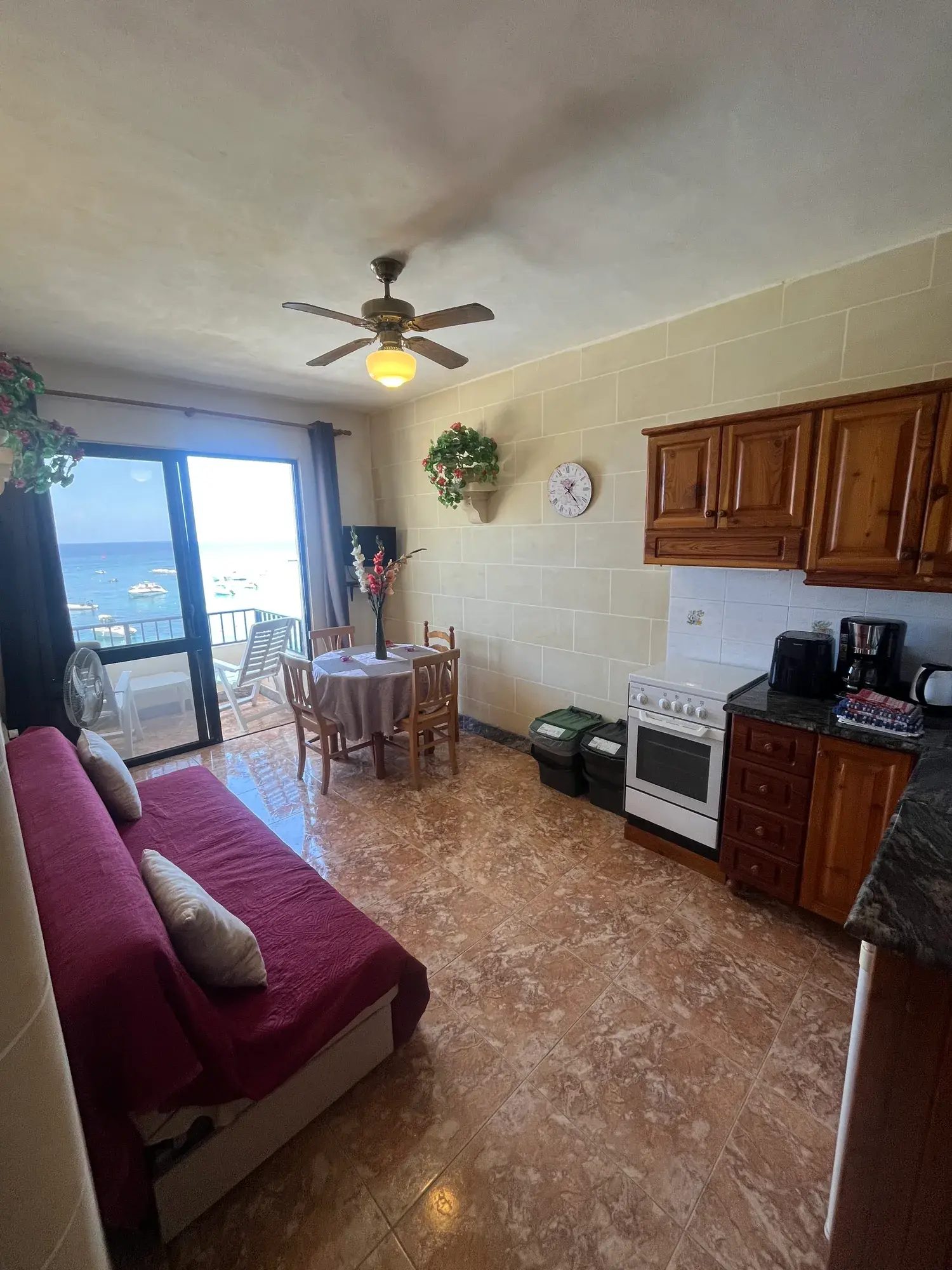 Sultana Apartment 4 living and kitchen area opening onto the sea-view balcony