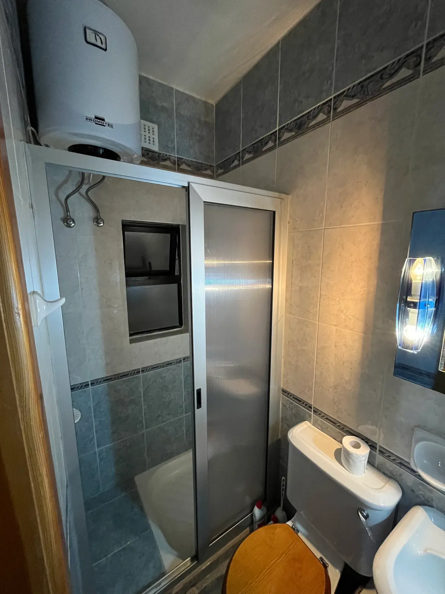 Tiled shower room with basin at Sultana Apartment 5