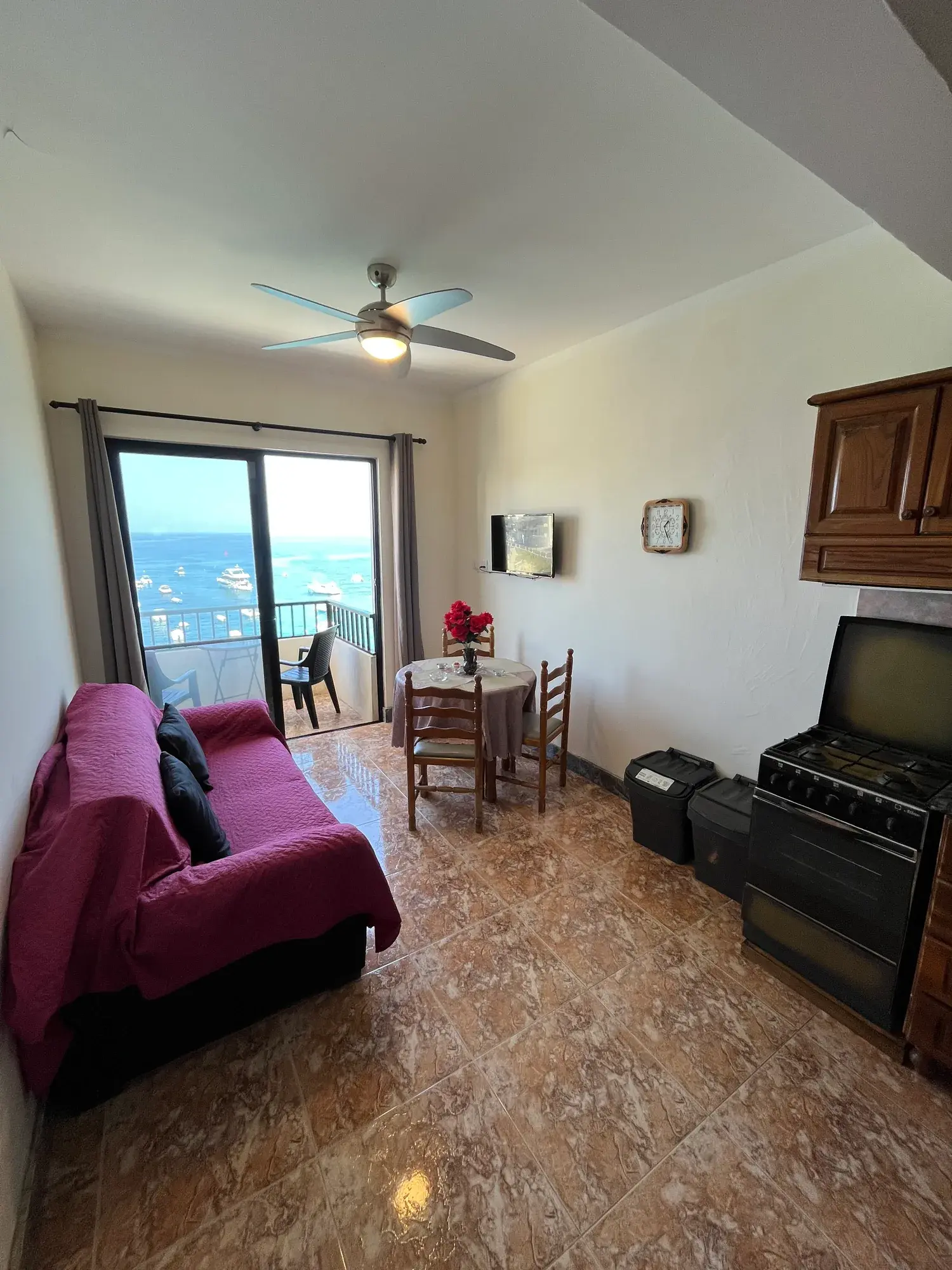 Sultana Apartment 8 living and dining area with a sea-view balcony