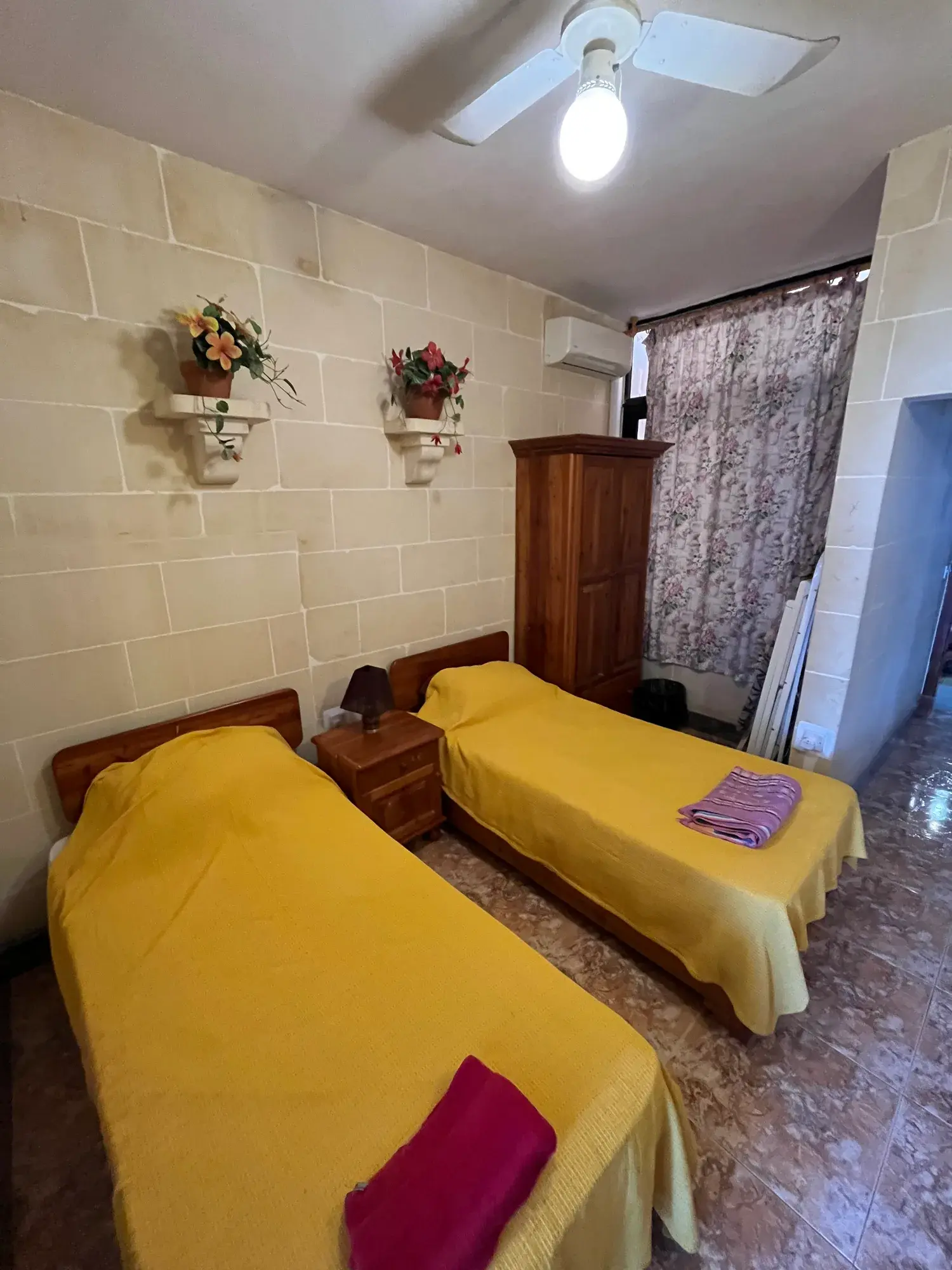 Twin bedroom with yellow bedspreads at Sultana Apartment 8