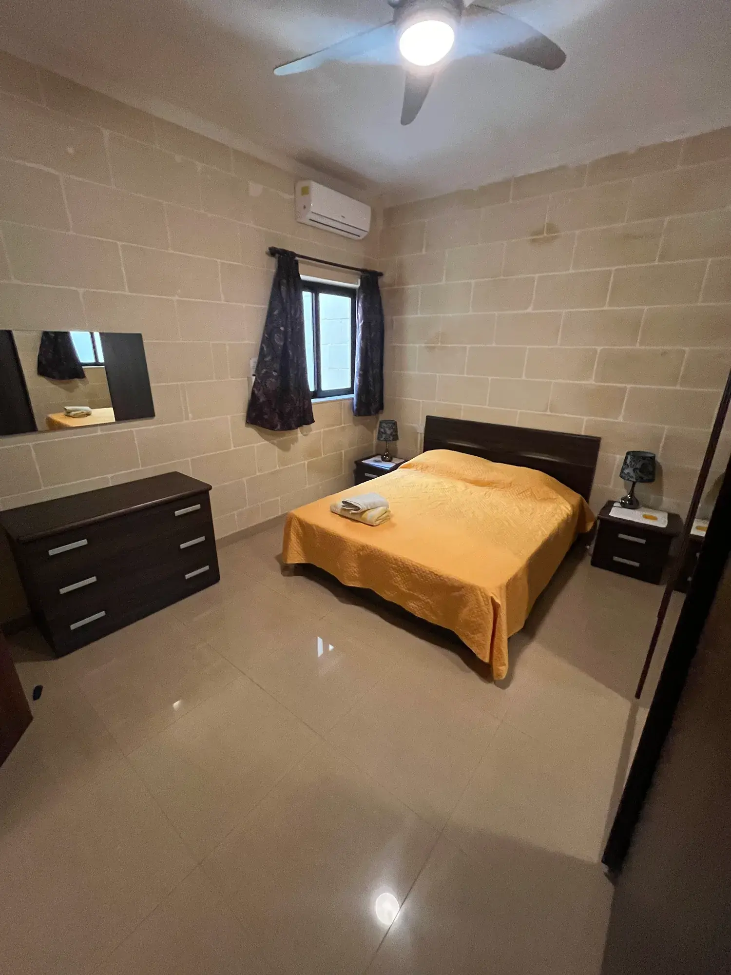 Double bedroom with golden bed linen at Vicmar Apartment 2
