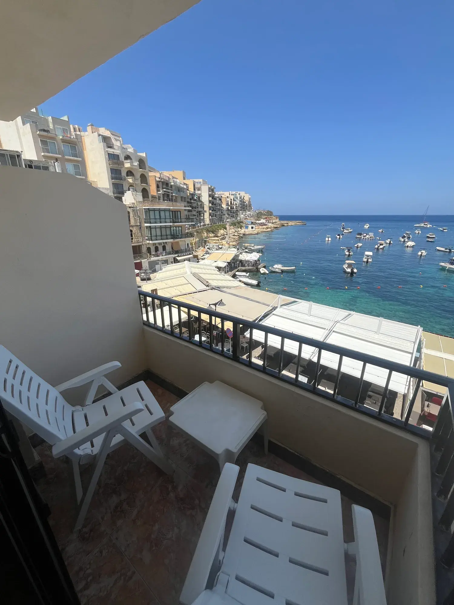 Sultana Apartment 4 balcony overlooking turquoise water and fishing boats